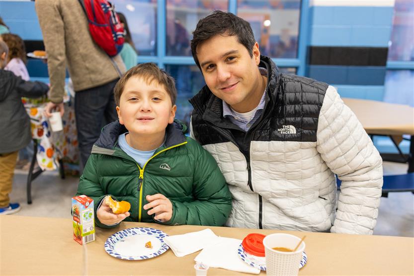 Trinity Elementary students eat donuts with dudes